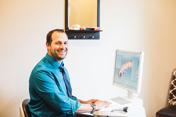 Dr. Aaron Wulf using the CEREC in-office milling machine for same-day crowns.