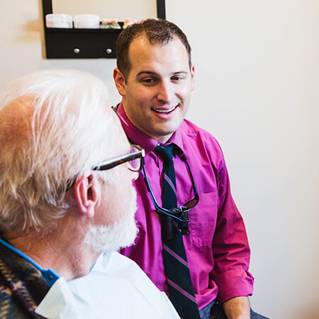 Dr. Aaron Wulff working with a patient's smile