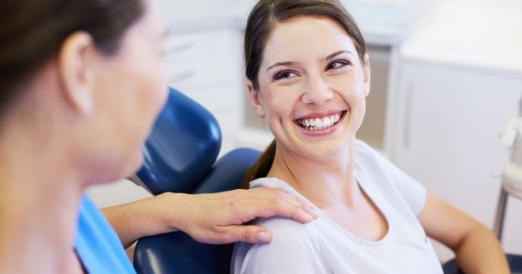 Woman smiling at dental professional.